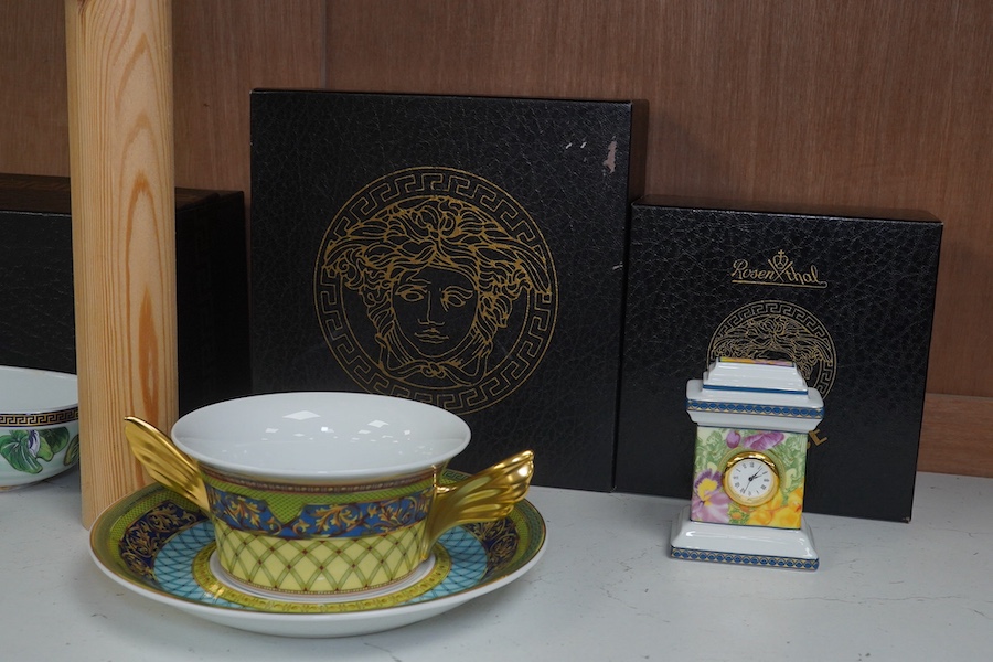 Six Rosenthal for Versace porcelain items; a boxed chocolate cup and saucer, four oblong serving dishes, longest 23cm, and a boxed miniature timepiece, 8.5cm high. Condition - good.